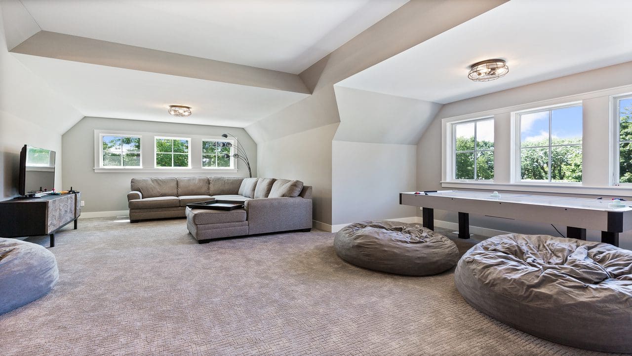 A living room with couches and pillows on the floor