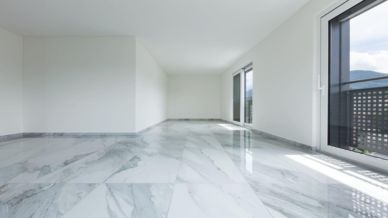 A room with white marble floors and walls.