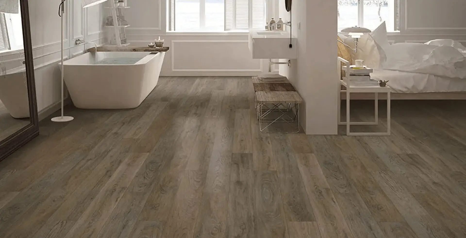 A bathroom with wood floors and white walls.